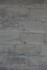 The old brick and stone wall with plaster