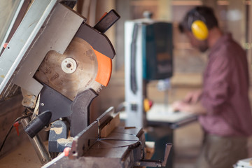 Circula Saw with Male Carpenter on background