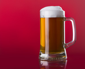 Light beer mug against the backdrop of the bar shelf