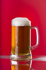 Light beer mug against the backdrop of the bar shelf