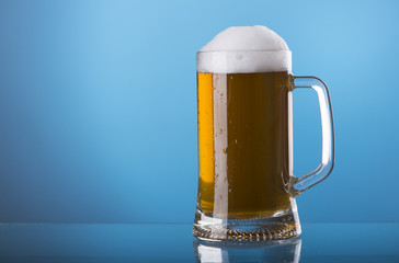 Light beer mug against the backdrop of the bar shelf