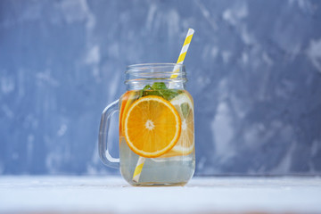 Detox water with lemon, orange and mint. Glass jar.The concept is summer, diet, vegetarian, fitness, healthy eating and lifestyle.