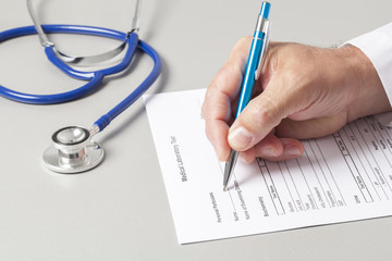 Doctor Filling Out Medical Form