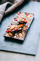 Useful raw chocolate with almonds, cranberries and hazelnuts