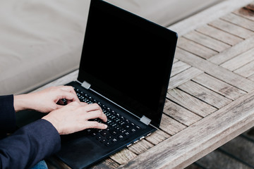 Asian Business woman hand typing on laptop on wood table, Holiday working startup concept.