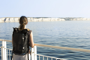 Woman backpacker crossing English channel by ferry from Dover to Calais