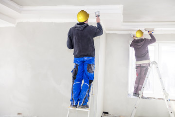 Construction workers fill the ceiling