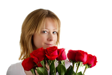 Young blonde European girl holding a bouquet of red roses on a white background