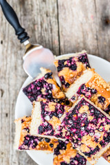 Sweet pastry baked with blueberry fruits on yeast cake, pieces on plate