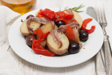 salad with anchovies on white plate