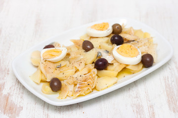 cod fish with boiled vegetables and egg on the dish