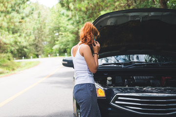 Women The car was broken on the highway. countryside. Women broken car