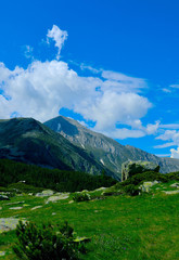 Beautiful view on the high green mountains peaks, on the blue sky background. Mountain hiking paradise landscape, no people.