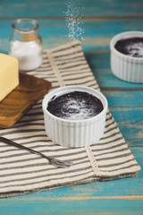 Chocolate homemade dark muffin on a blue wooden table