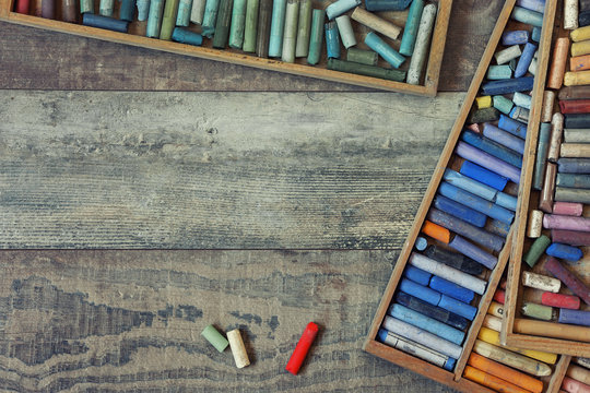 Premium Photo  Collection of rainbow colored artistic pastel crayons with  pigment dust on old wooden desk