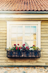flower box hanging in front of old wooden house window