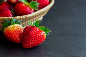 Fresh strawberries on granite background. Ripe strawberry in basket on granite table. Copy space background of strawberry for your design. Extremely exposure fruit  concept background or wallpaper.