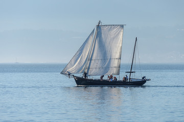 Fototapeta premium sailing yacht sails against the sunset