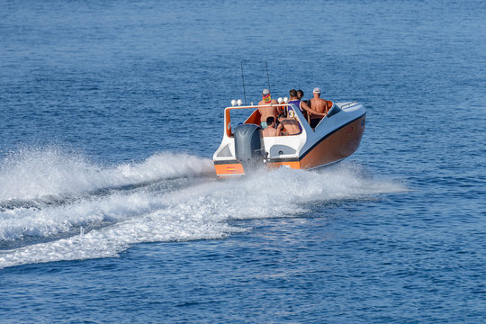 people ride a motor boat in the sea