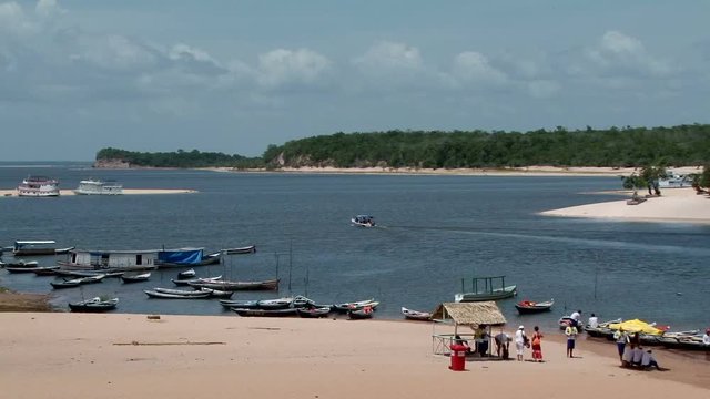 Static shot of sandy beaches at Alter do Chao, Para state, Brazil. A lots small wooden boats tied up on the forehead 