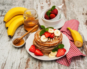 Pancakes with strawberries and bananas