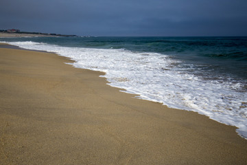Fototapeta na wymiar On a beach by the water of the sea, Atlantic Ocean.