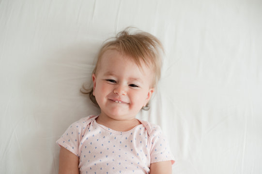 Beatiful baby smiling in bed