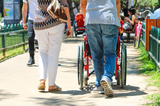 Two adults with a disabled wagon in the city