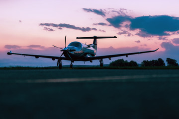 Single turboprop aircraft on evening runway.