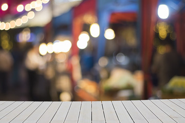 Wooden empty table with blurred background. gray wooden board on blurred on walking street shop. Mock up for text