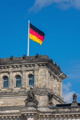 Fototapeta na wymiar detail of the german flag on the top of an ancient building in berlin
