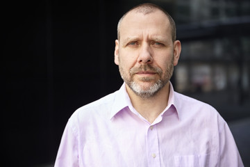 Mature office worker in front of his office