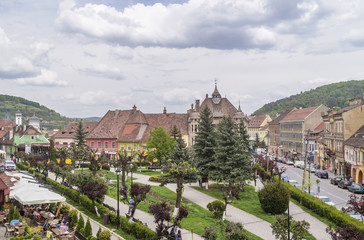 Dramatic sky over Hermann Oberth Square, historic center of Sighisoara, Romania