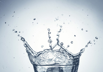 Fototapeta na wymiar splashing in glass of water