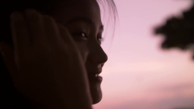 Closeup Of Young Asian Woman Silhouetted Face At Dusk
