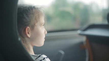 A little girl is traveling in a tourist bus - Powered by Adobe