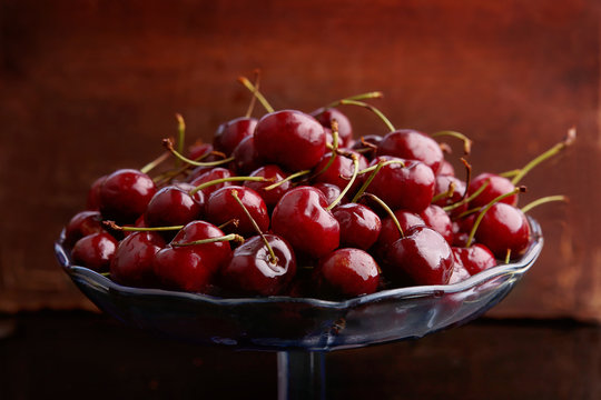 Cherries in glass bowl. Fruits cherries in glass stand.