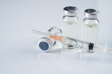 Medical ampoules, infusion and syringe with injection isolated on white background with copy space....