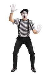 Mime holding his hands on an invisible wall
