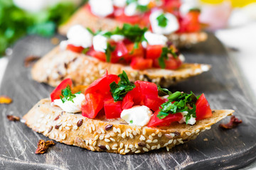 Bruschetta with tomatoes and curd cheese on whole wheat bread