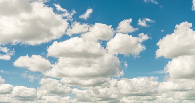 Time lapse clip of white fluffy rolling clouds