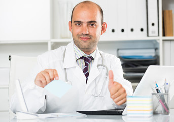Male working in medical Center at the laptop