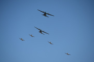 A group of Two Fixed Wing Aircrafts and Four Gray Fighter Aircrafts