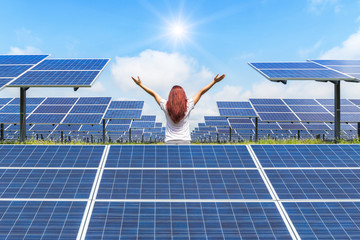     Solar power station with asian women standing raised up arms celebrate.  Ecology concept.   