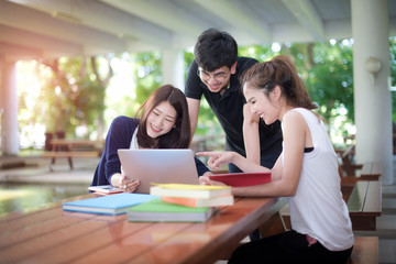 group of asian students are in attending of tutorial the subject on each other under building of the University