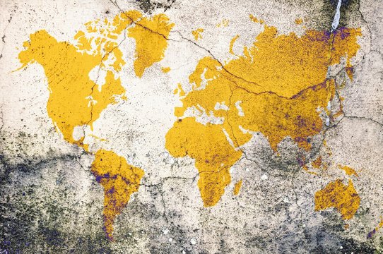 Yellow world map on damaged cracked concrete wall. Elements of this image furnished by NASA.
