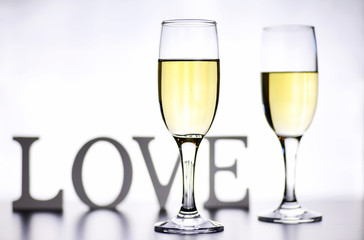 glass of white wine on a table on white background isolate