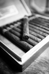 Retro styled photo of large box of Cuban cigars on a wooden table