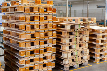 Stacked wooden pallets at a storage