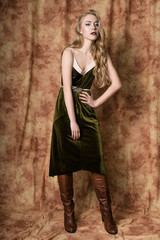 Fototapeta premium Beautiful fashion model in a velvet green dress. Vintage. Luxury style.